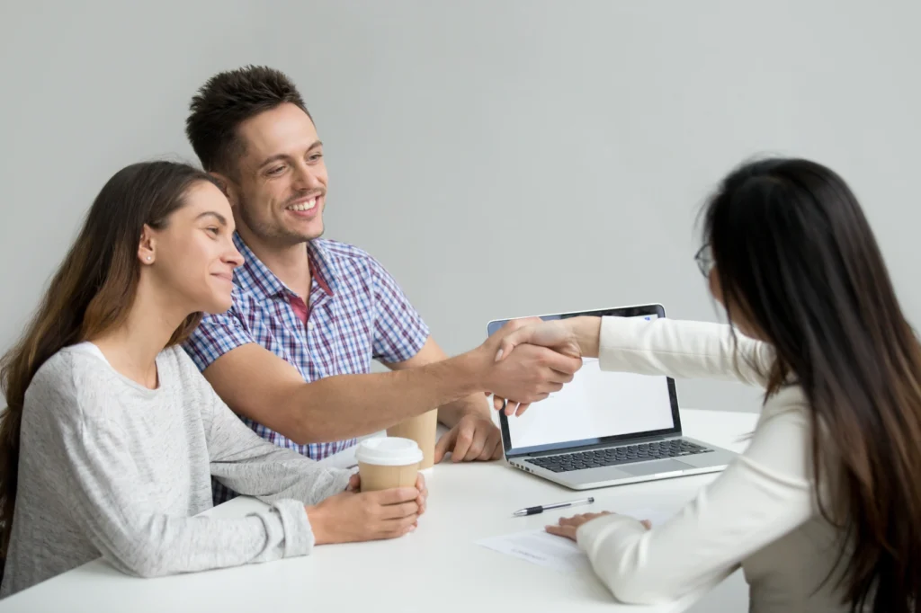 happy-couple-greeting-financial-consultant
